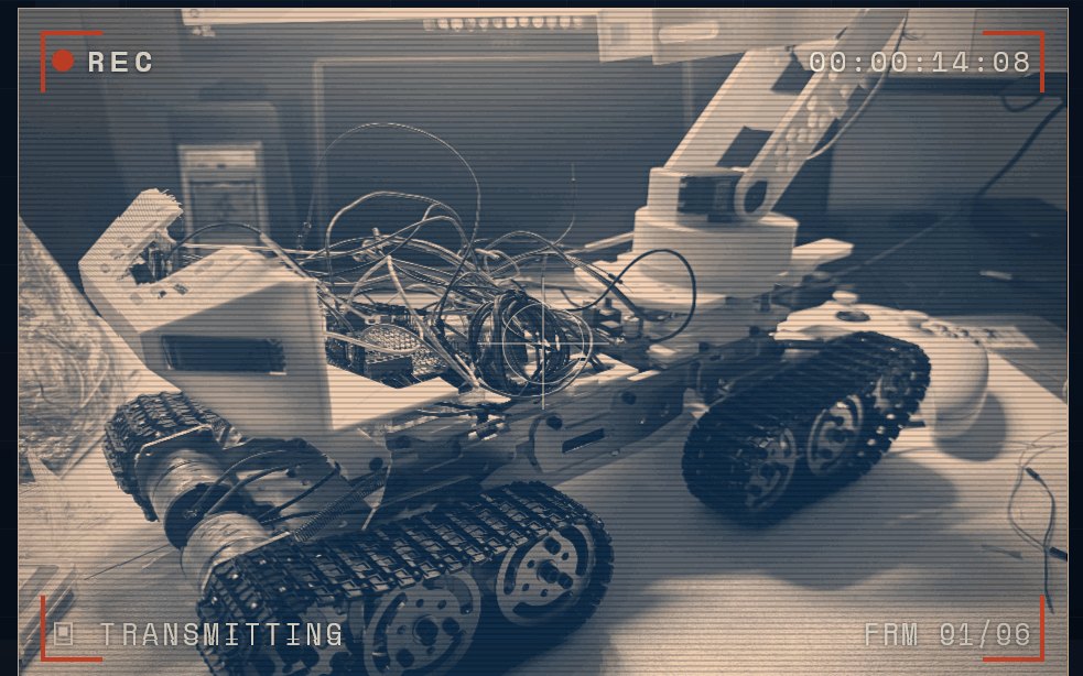 ATLAS autonomous field rover with tank treads and manipulator arm, in a field-log viewfinder