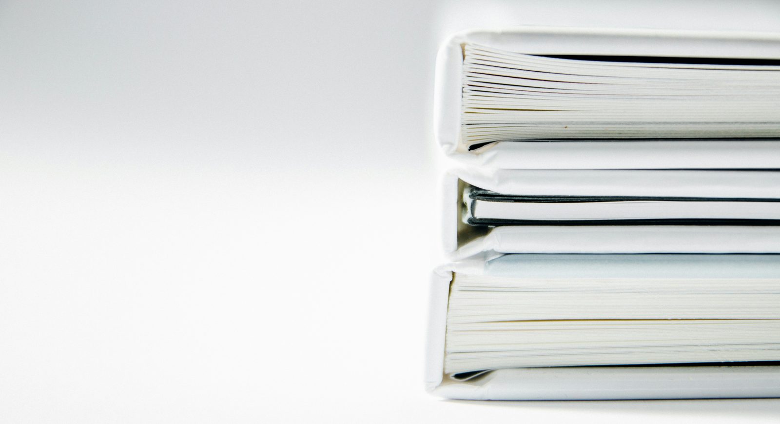 Stack of bound technical document sets