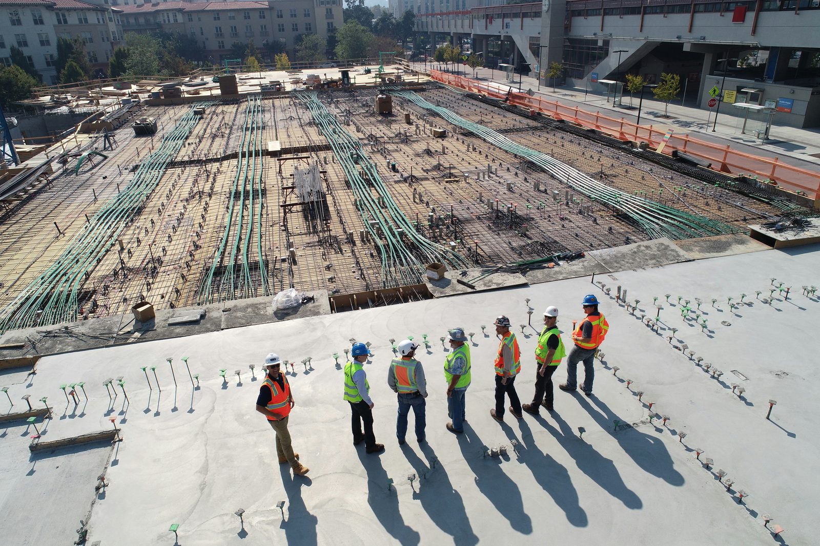 Engineering team on an active construction site with rebar and conduit