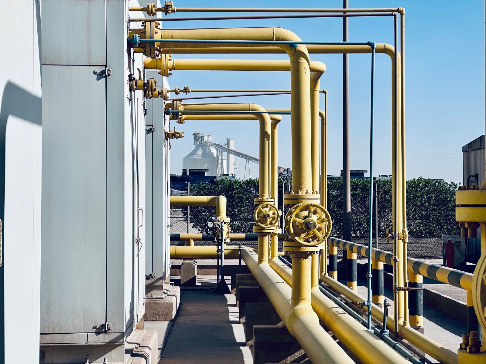 Industrial piping and valve systems at a process facility