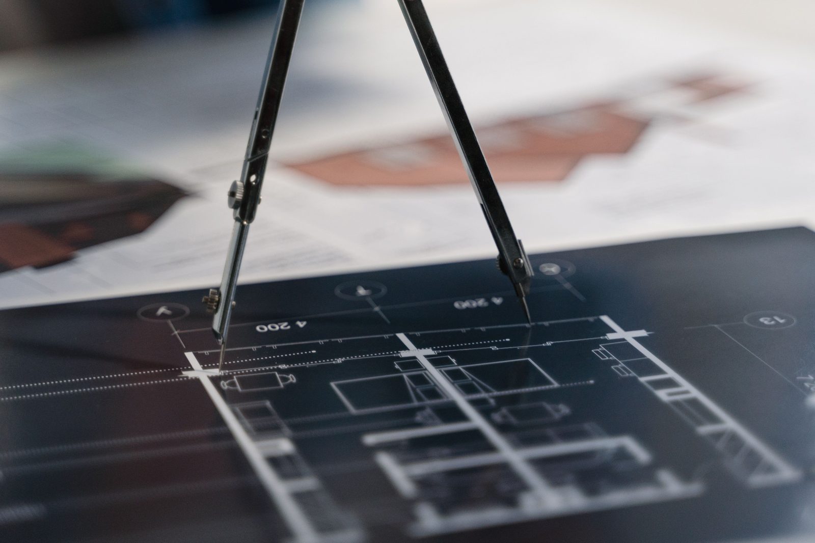 Drafting compass on a technical layout drawing